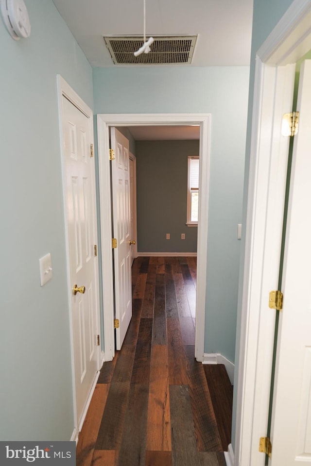 hallway with dark hardwood / wood-style floors