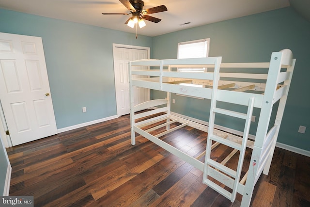 bedroom with ceiling fan, a closet, and dark wood-type flooring