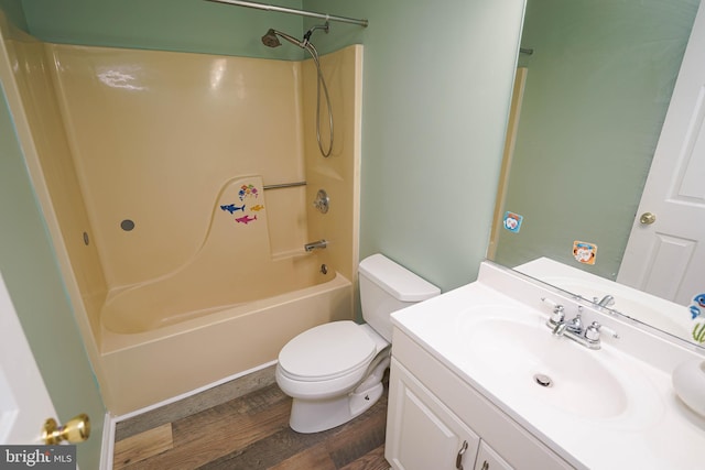 full bathroom with hardwood / wood-style floors, vanity, bathtub / shower combination, and toilet