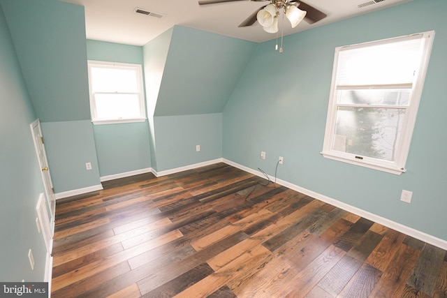 bonus room featuring vaulted ceiling, ceiling fan, and dark wood-type flooring