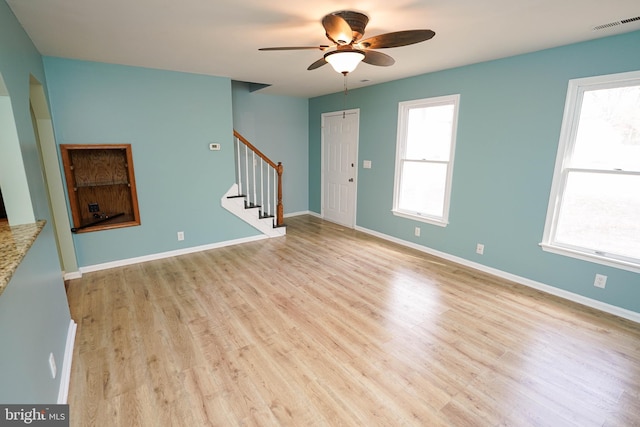 unfurnished living room with ceiling fan and light hardwood / wood-style flooring