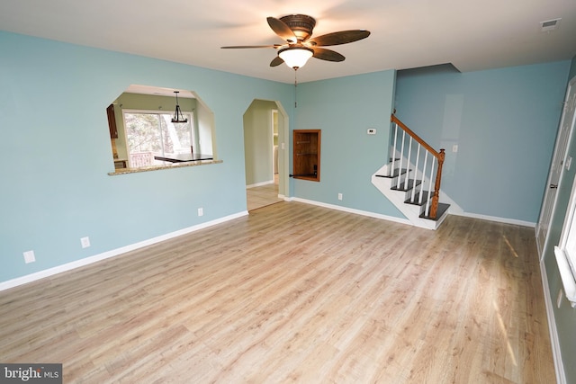 unfurnished living room featuring ceiling fan and light hardwood / wood-style flooring