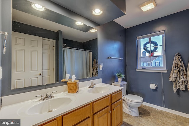 bathroom featuring tile patterned floors, vanity, a shower with shower curtain, and toilet