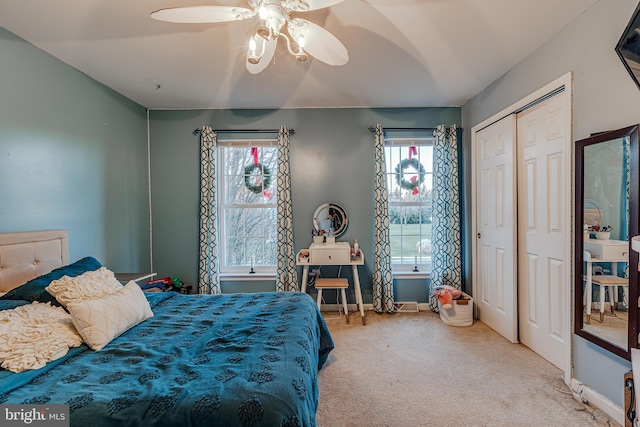 bedroom featuring ceiling fan, a closet, and light carpet