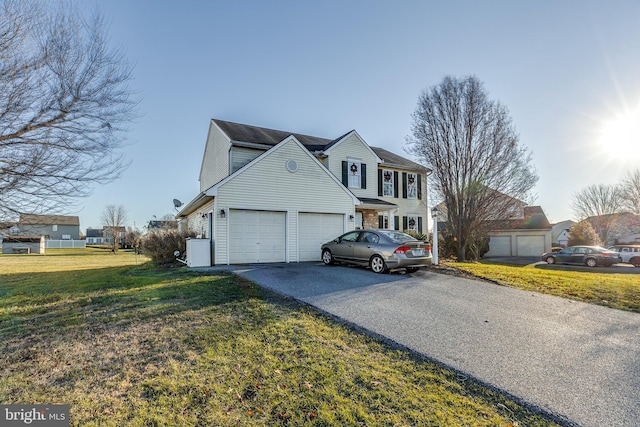 front of property with a front yard and a garage