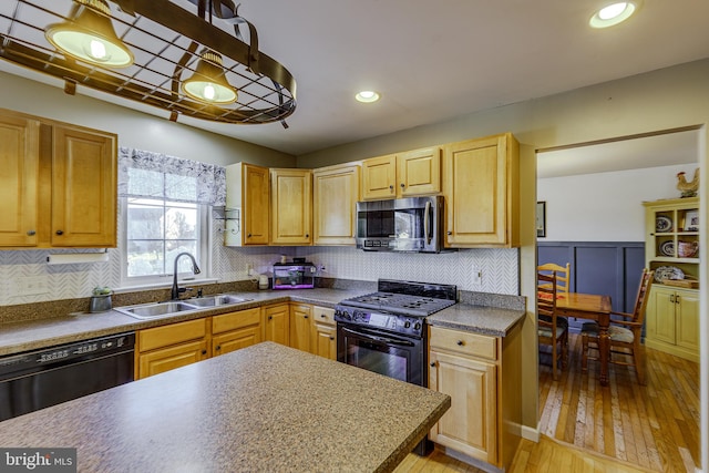 kitchen featuring black appliances, decorative backsplash, light wood-type flooring, and sink