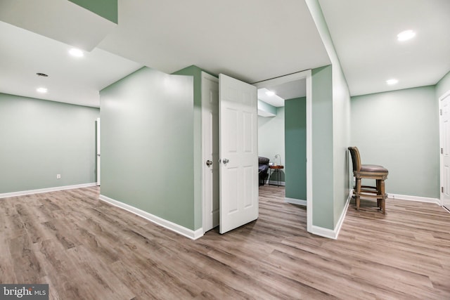 basement with light hardwood / wood-style floors