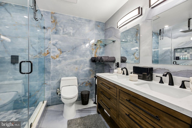 bathroom featuring vanity, a shower with door, toilet, and tile walls