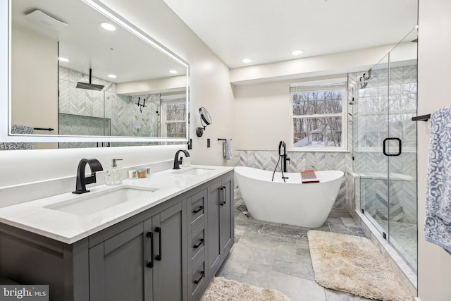 bathroom with vanity and independent shower and bath