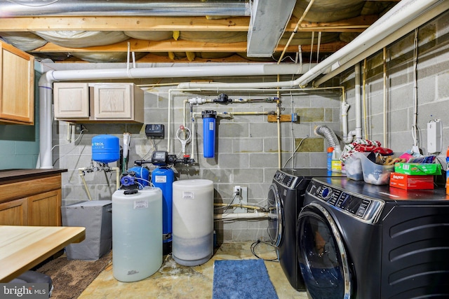 clothes washing area featuring cabinets and independent washer and dryer