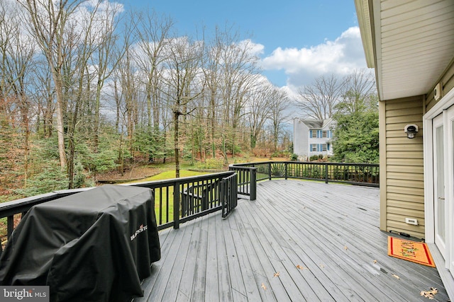 wooden deck with a grill