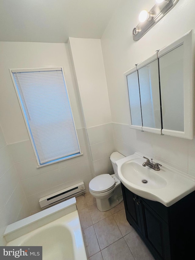 bathroom with tile patterned floors, vanity, baseboard heating, tile walls, and toilet