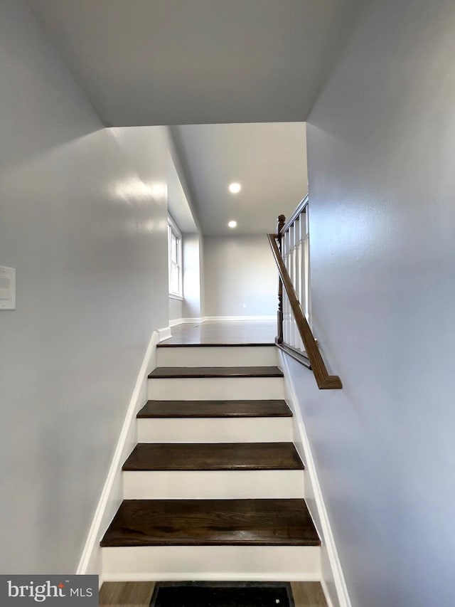 staircase with hardwood / wood-style flooring