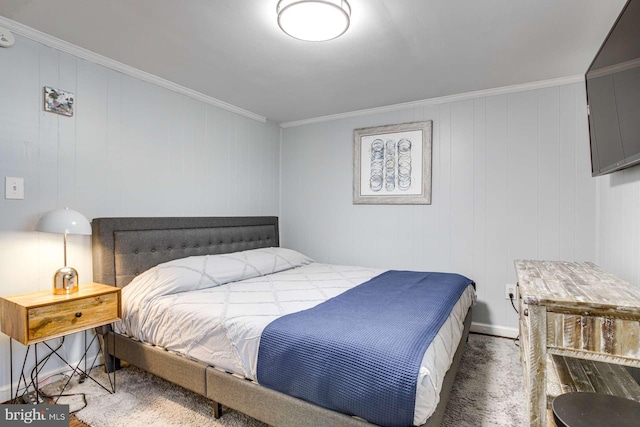 carpeted bedroom with wood walls and ornamental molding