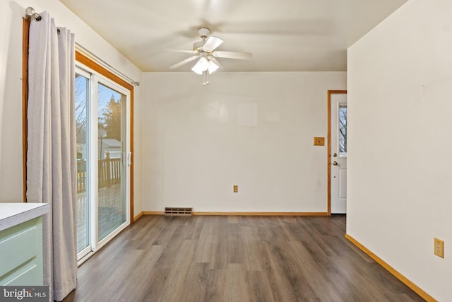 unfurnished room featuring ceiling fan and dark hardwood / wood-style flooring