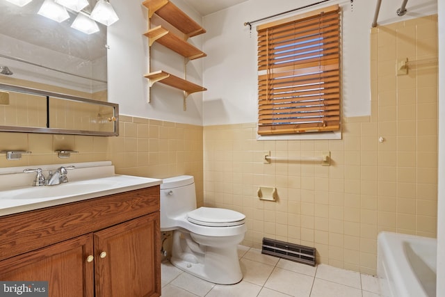 bathroom with tile patterned flooring, vanity, toilet, and tile walls