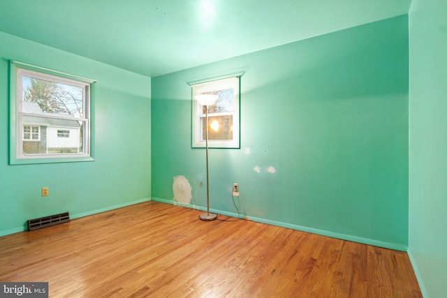 unfurnished room with light wood-type flooring