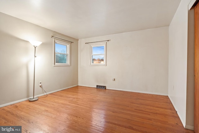 spare room featuring light hardwood / wood-style floors