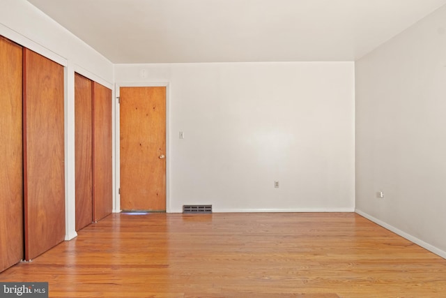 unfurnished bedroom with light wood-type flooring