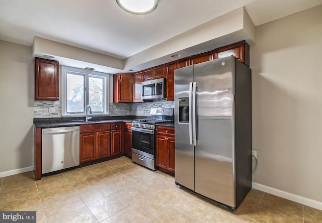 kitchen featuring decorative backsplash, light tile patterned floors, sink, and appliances with stainless steel finishes