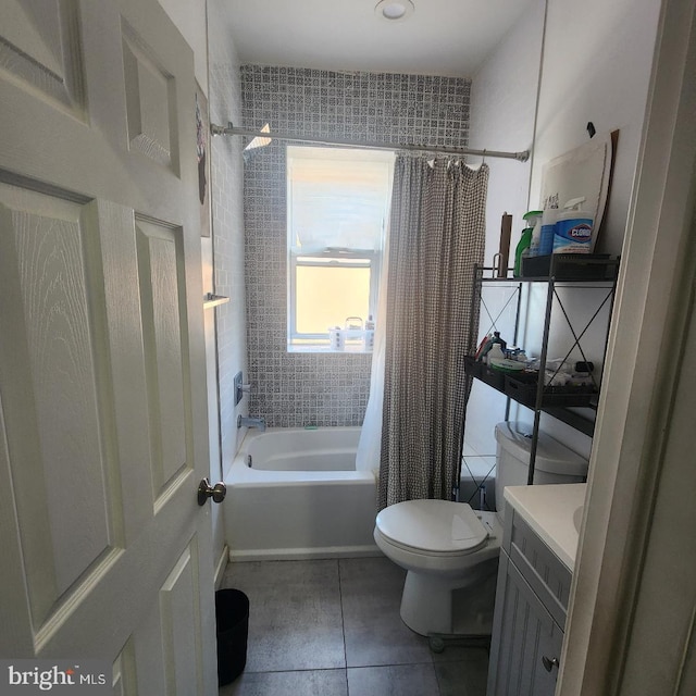 full bathroom featuring toilet, shower / bath combo with shower curtain, vanity, and tile patterned flooring