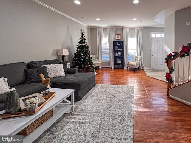 living room featuring crown molding and hardwood / wood-style floors