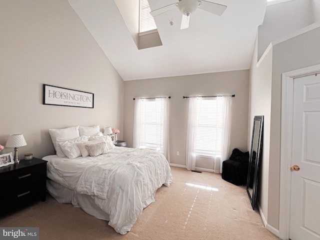 carpeted bedroom featuring ceiling fan and high vaulted ceiling