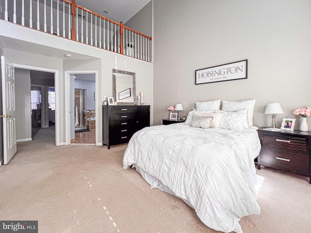 carpeted bedroom featuring a towering ceiling