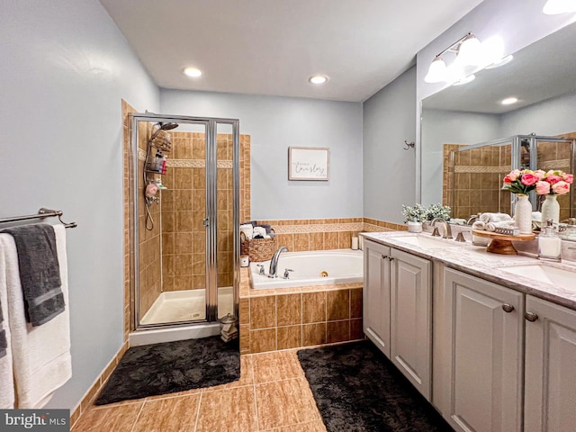 bathroom with tile patterned flooring, vanity, and separate shower and tub