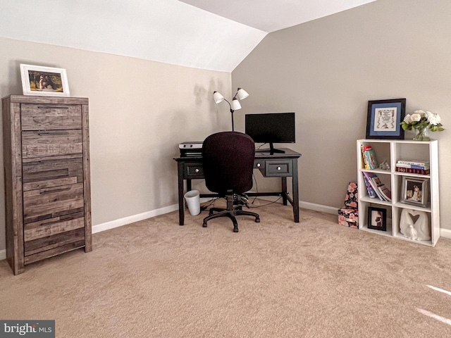 office area featuring light carpet and vaulted ceiling