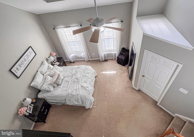 bedroom with ceiling fan, light colored carpet, and lofted ceiling