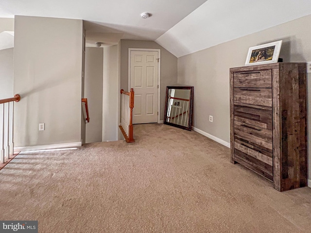 additional living space featuring light carpet and lofted ceiling