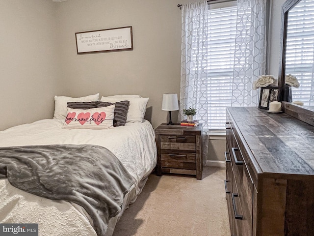 bedroom with light colored carpet