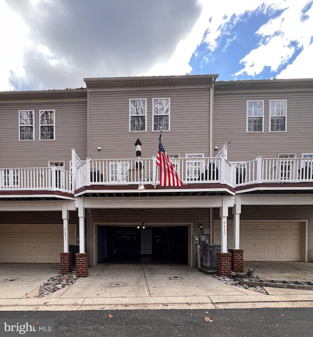 rear view of property featuring a garage