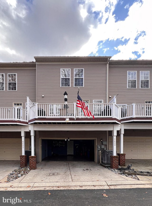 rear view of property with a garage