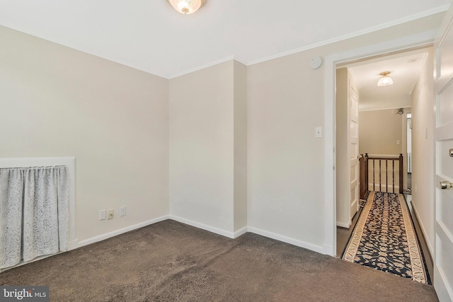 unfurnished room with dark carpet and ornamental molding