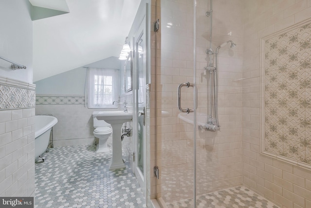 bathroom featuring tile walls and plus walk in shower