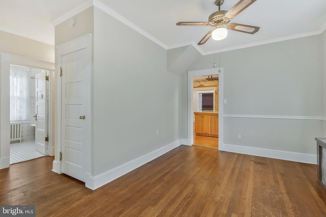 unfurnished room with radiator heating unit, wood-type flooring, ornamental molding, and ceiling fan