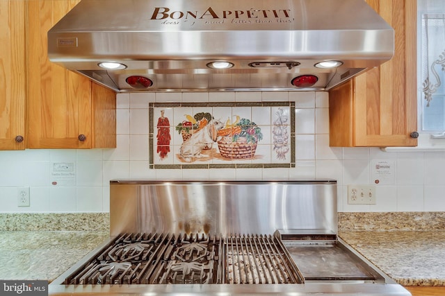 interior details featuring tasteful backsplash, range hood, and light stone countertops