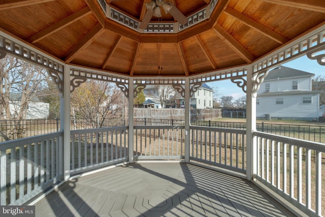 wooden terrace with a gazebo and ceiling fan