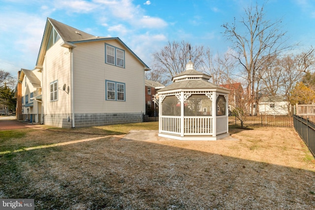 view of side of home featuring a gazebo and a lawn