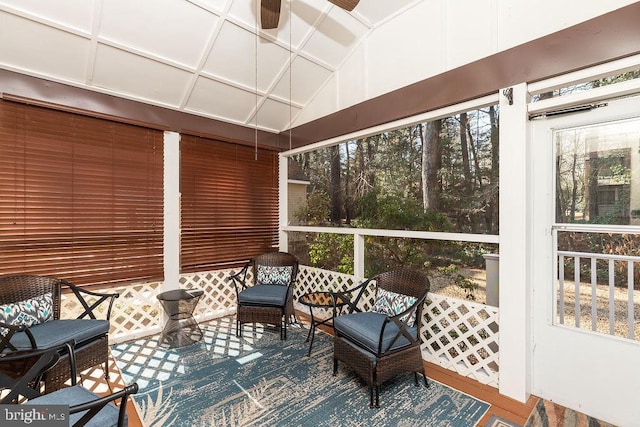 sunroom with ceiling fan and lofted ceiling