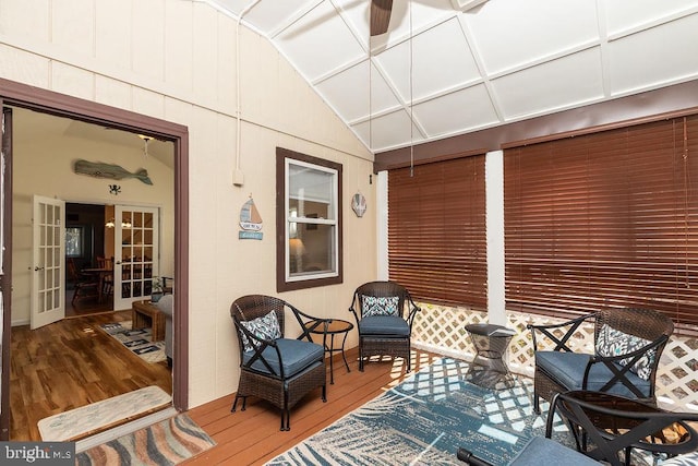 sunroom featuring french doors and lofted ceiling