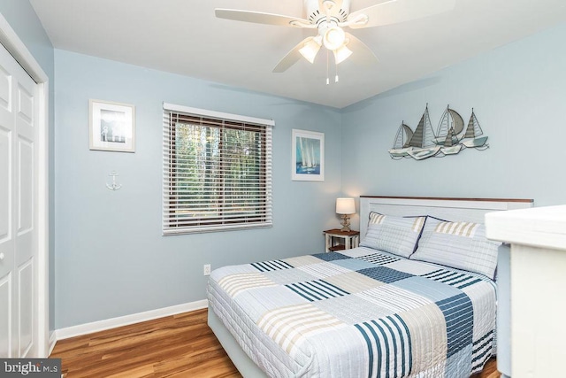 bedroom featuring ceiling fan, a closet, and light hardwood / wood-style flooring