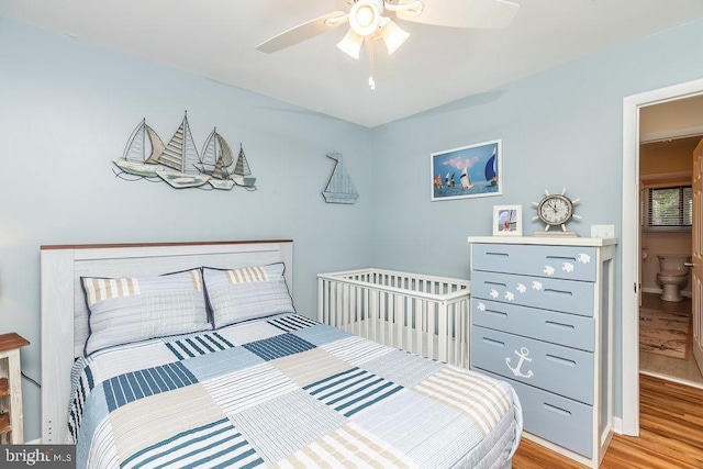 bedroom with ceiling fan, light hardwood / wood-style flooring, and ensuite bathroom