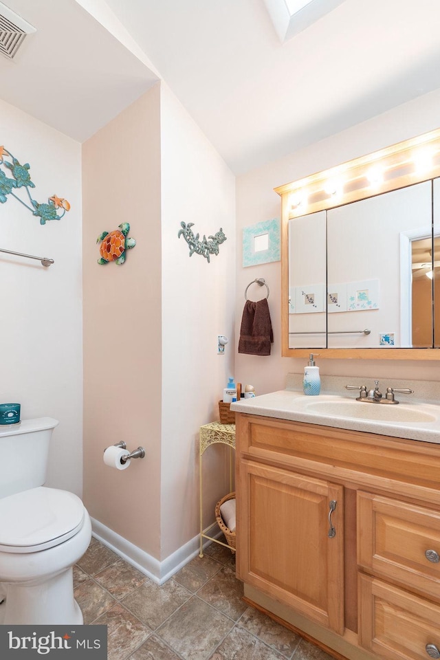 bathroom with tile patterned floors, vanity, and toilet