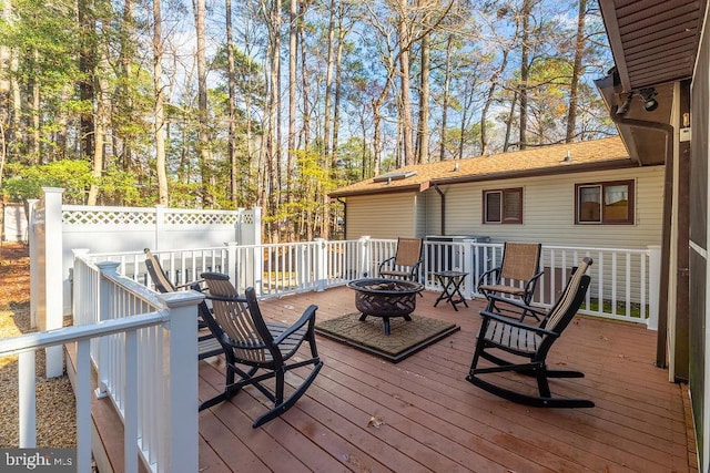 deck featuring an outdoor fire pit