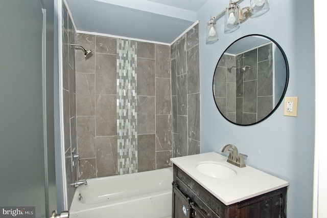 bathroom with vanity and tiled shower / bath