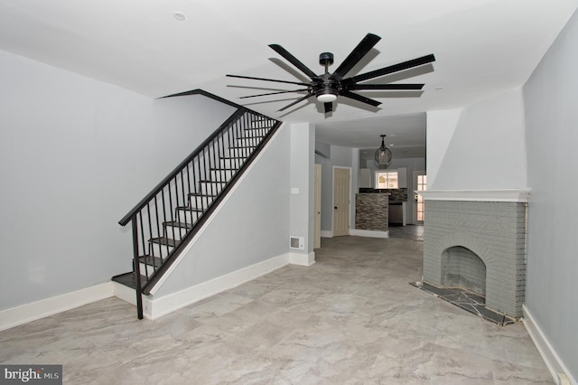 unfurnished living room featuring a fireplace and ceiling fan