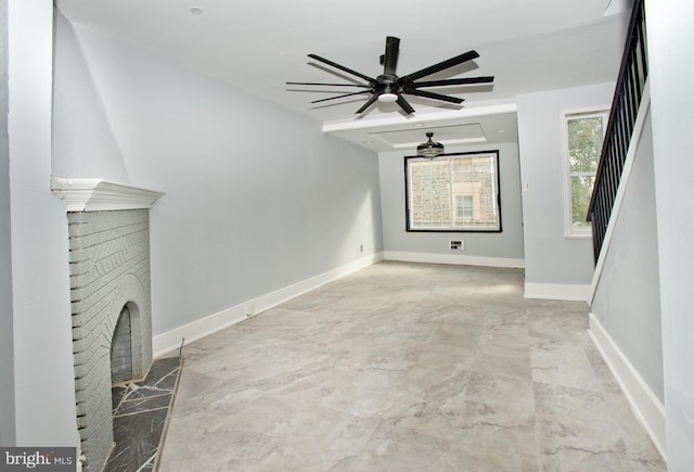 unfurnished living room with a brick fireplace and ceiling fan